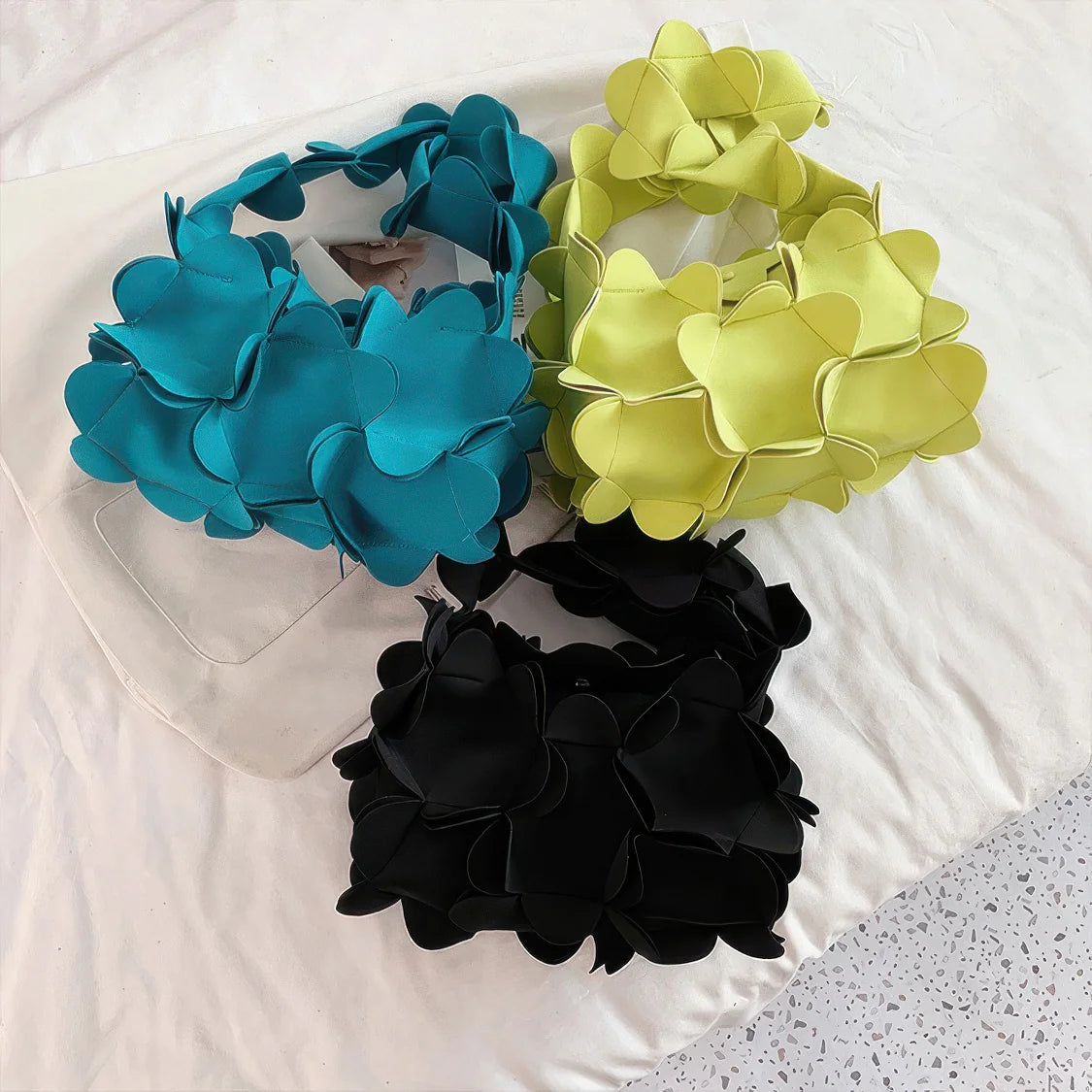 Three floral headbands in blue, green, and black on a white surface. #Addtl