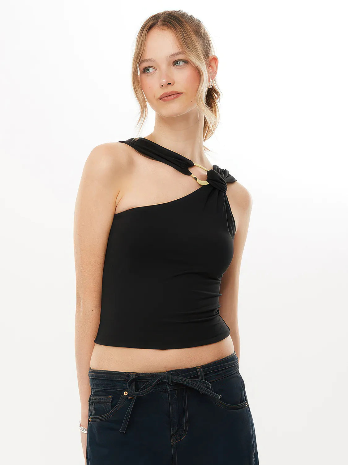 Woman wearing a black one-shoulder top with a knot detail on a white background #Color_Black