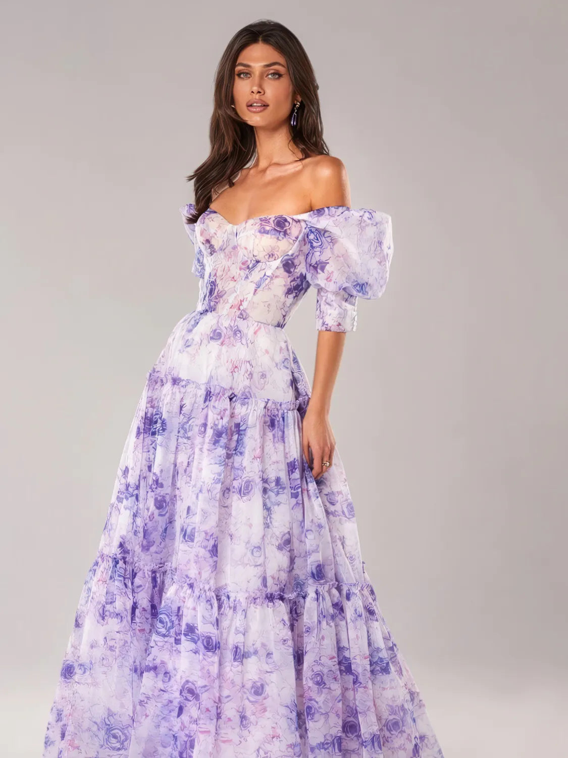 Woman wearing a floral off-shoulder dress against a gray background. #Color_Purple