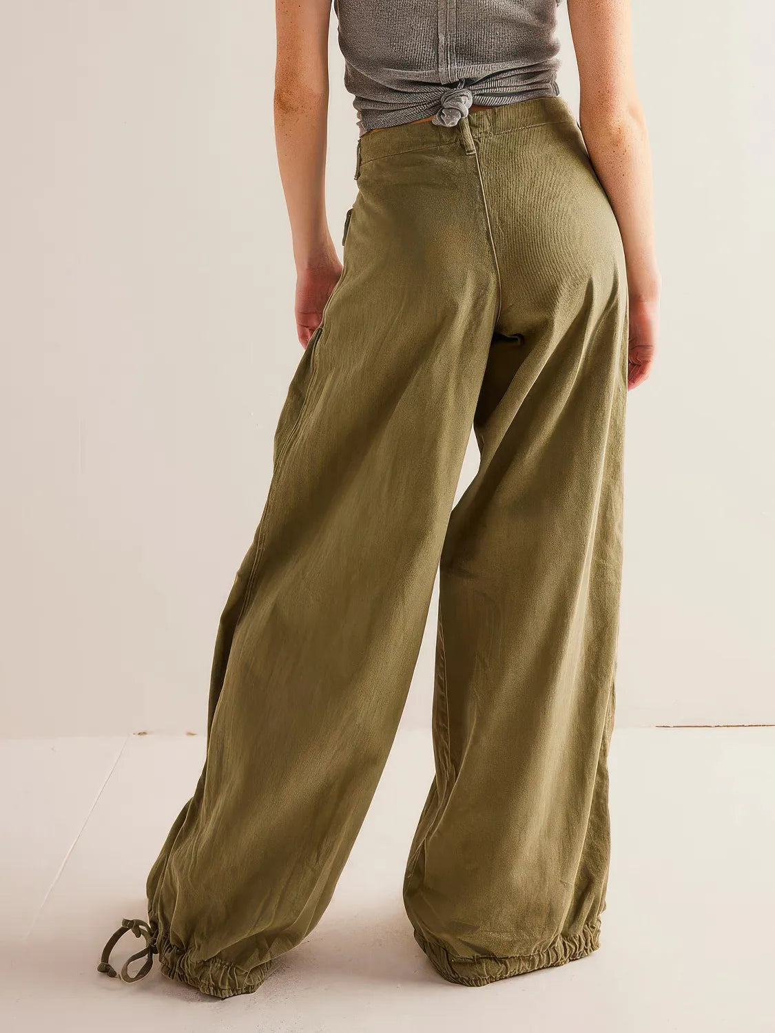 Person wearing olive green wide-leg pants on a plain background. #Color_OliveDrab