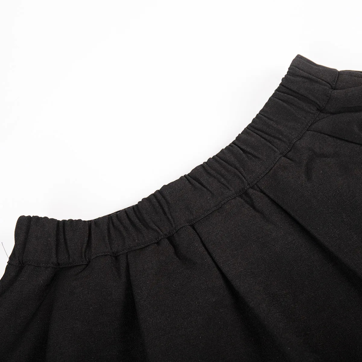 Close-up of black pants with a white background. #Color_Black