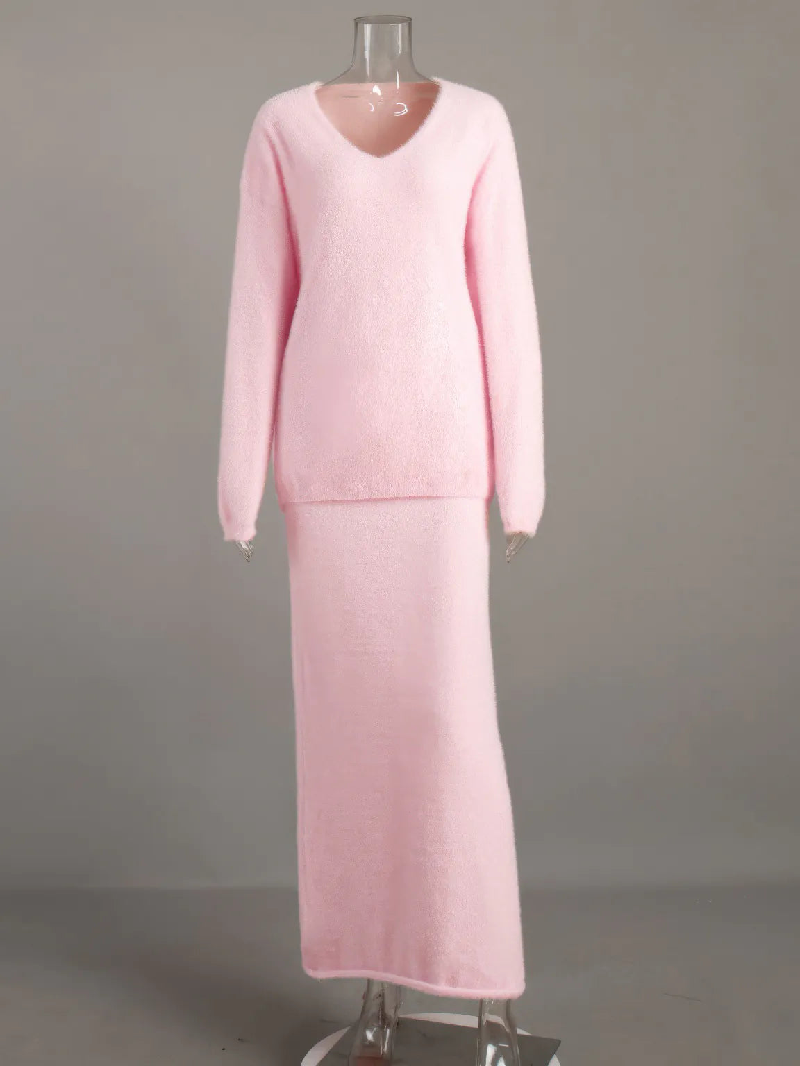 Pink dress on a mannequin against a gray background. #Color_Pink