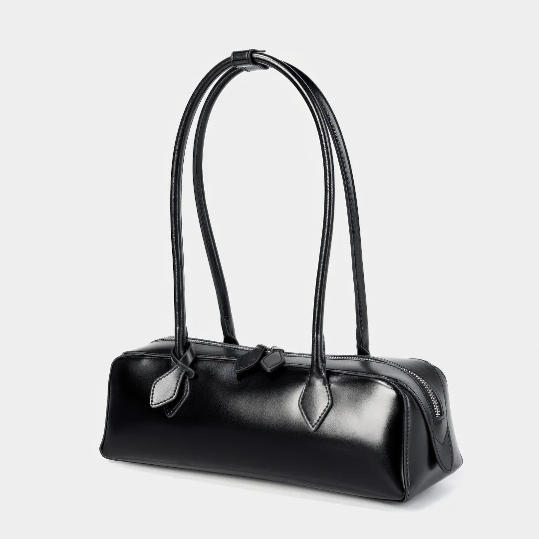 Black handbag with a bow detail on a light gray background #Color_Black