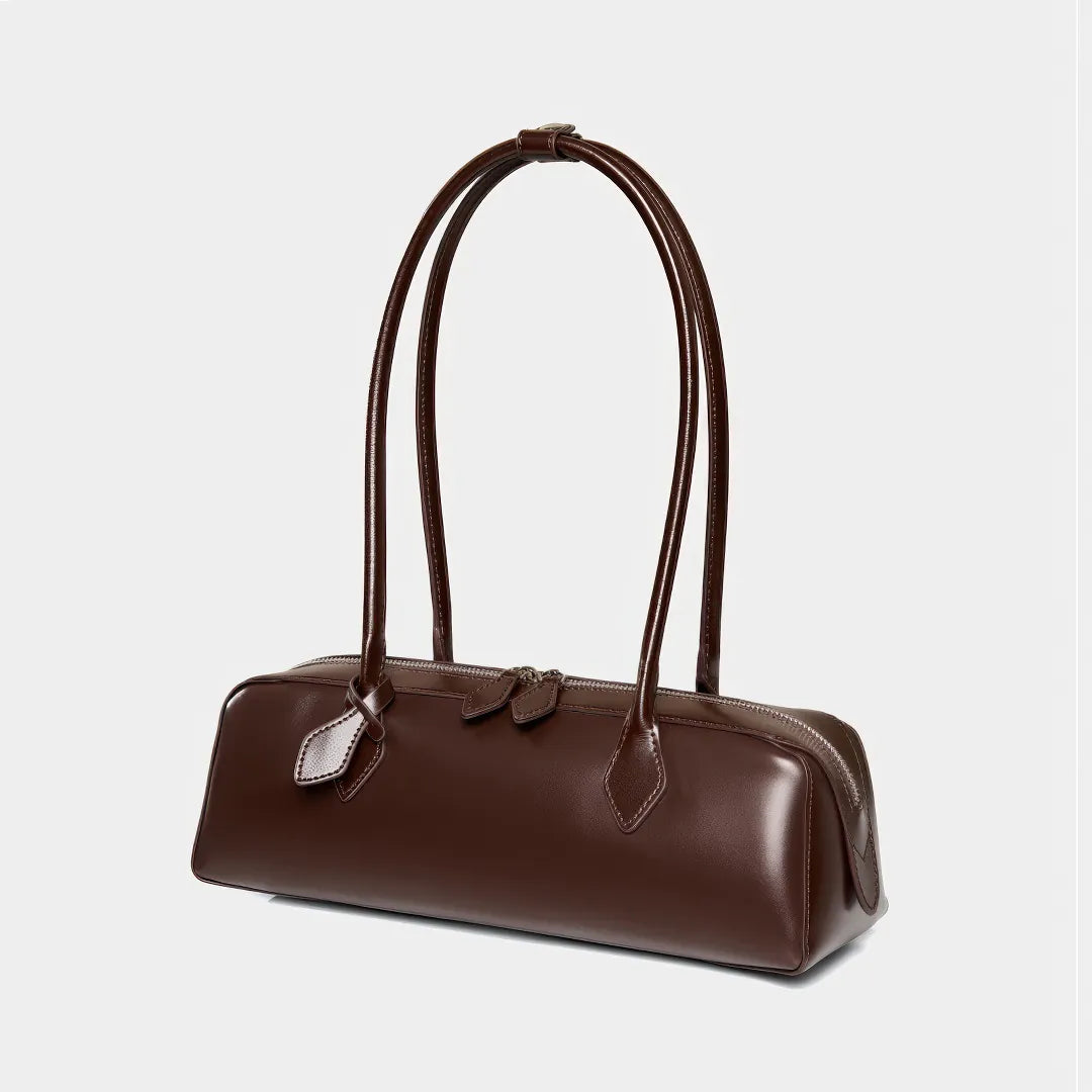 Brown leather handbag with handles on a light gray background #Color_Brown