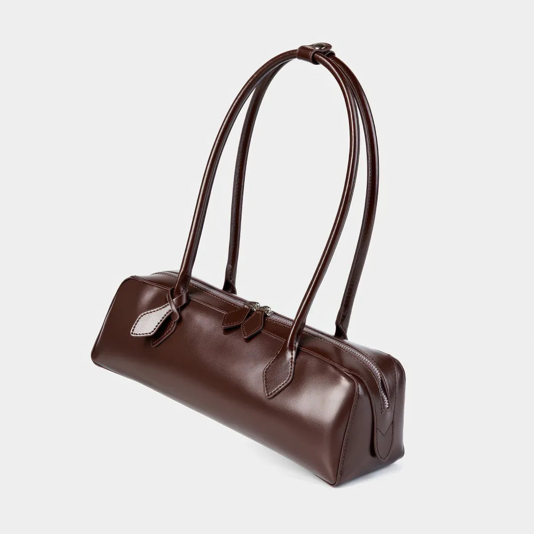 Brown leather handbag on a light gray background #Color_Brown