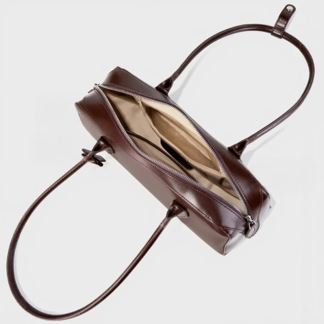 Brown leather handbag with open top on a light gray background #Color_Brown