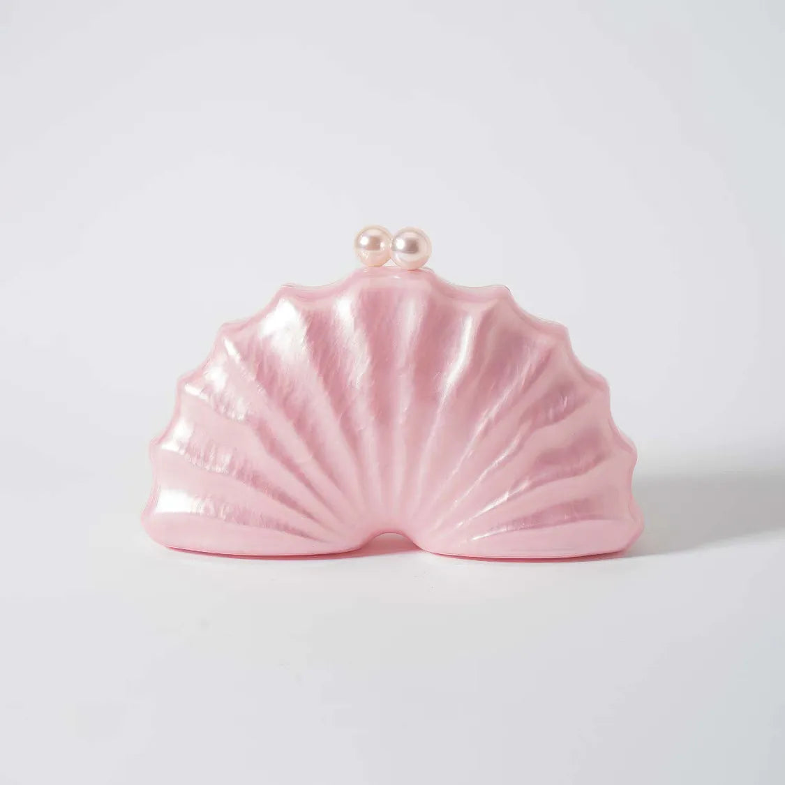 Pink shell-shaped clutch bag with pearl accents on a light gray background. #Color_Pink