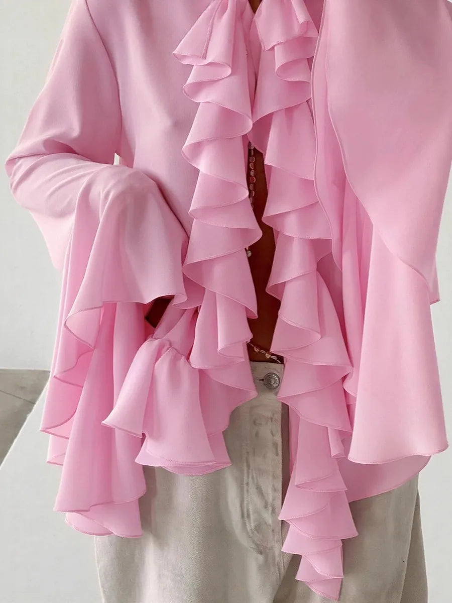 Pink ruffled blouse with a plain background #Color_Pink