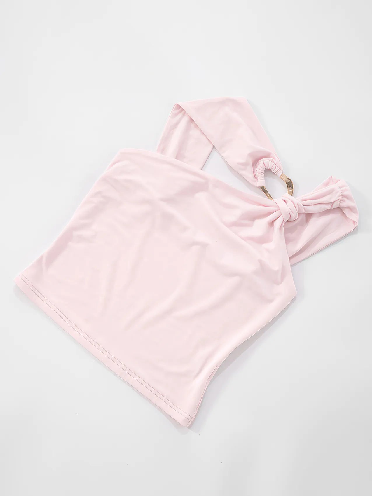 Pink halter top with a bow detail on a light gray background #Color_Pink