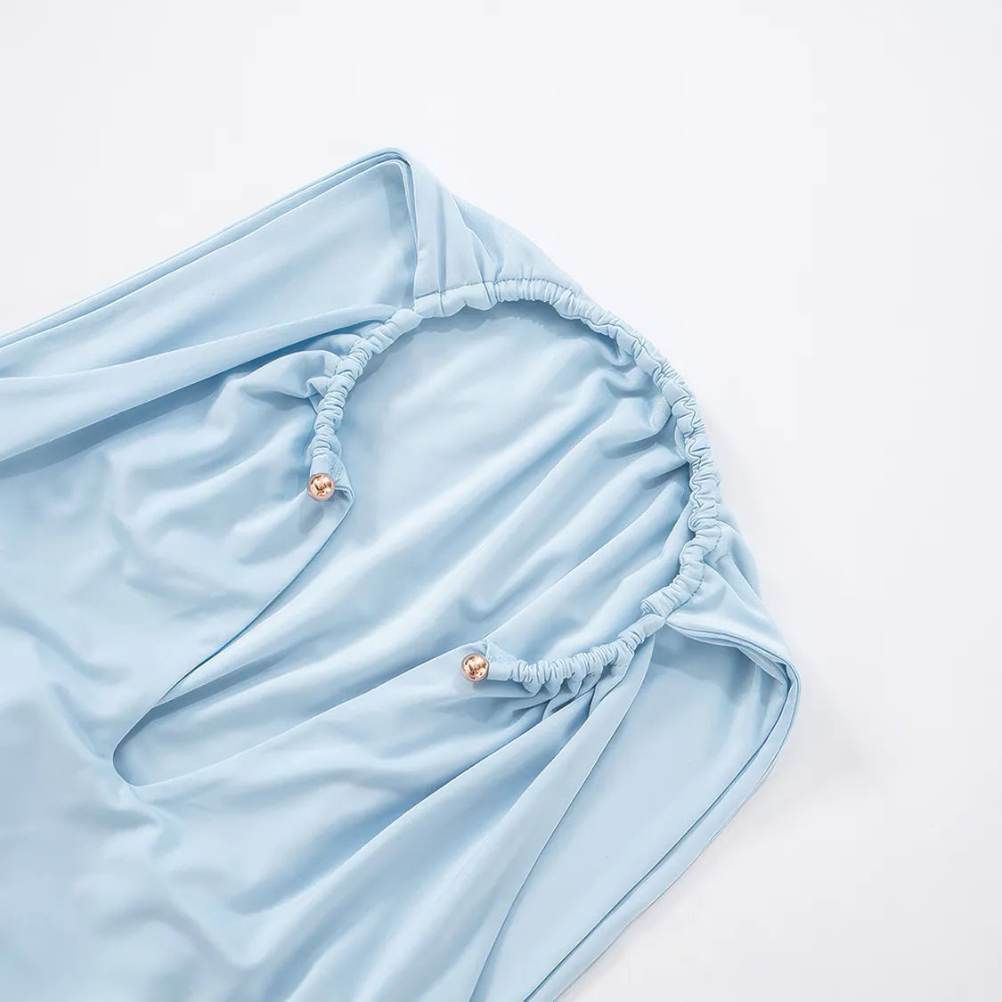 Light blue fitted sheet on a bed with a white background #Color_LightBlue