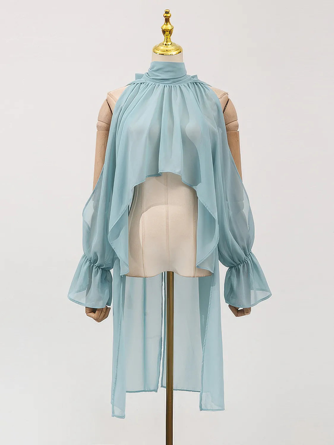 Light blue chiffon blouse on a mannequin against a light gray background. #Color_Blue