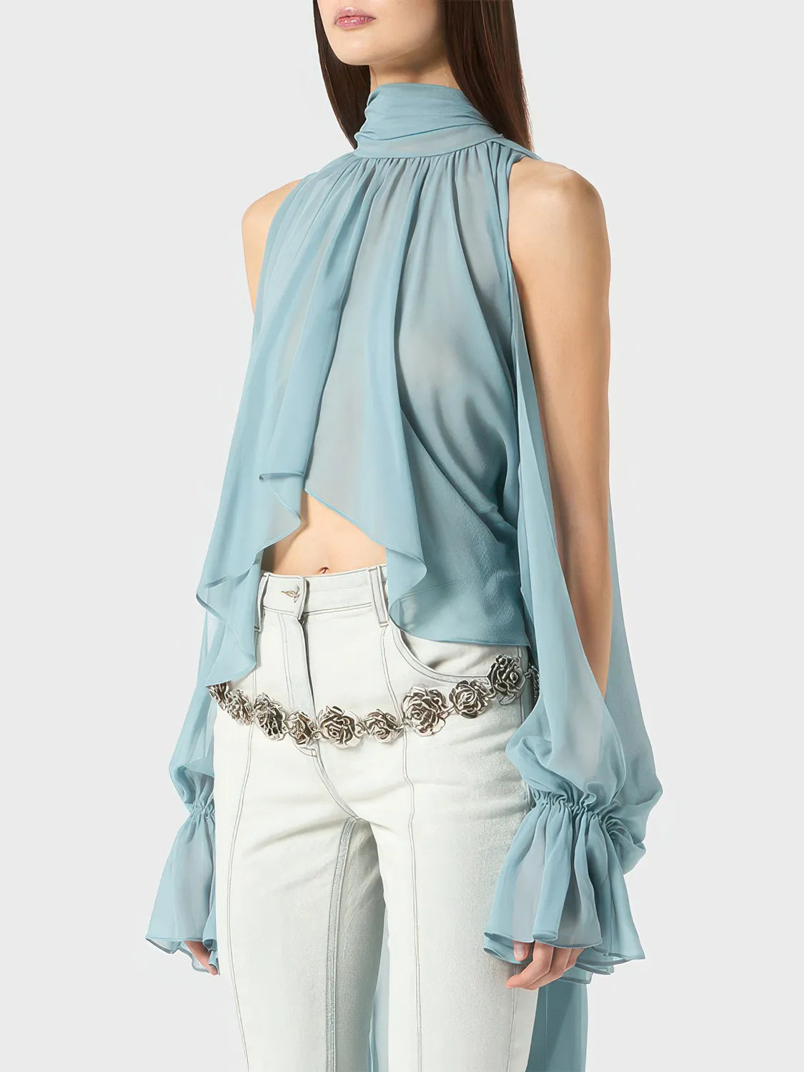 Light blue sleeveless top with a high neckline and white pants on a plain background. #Color_Blue