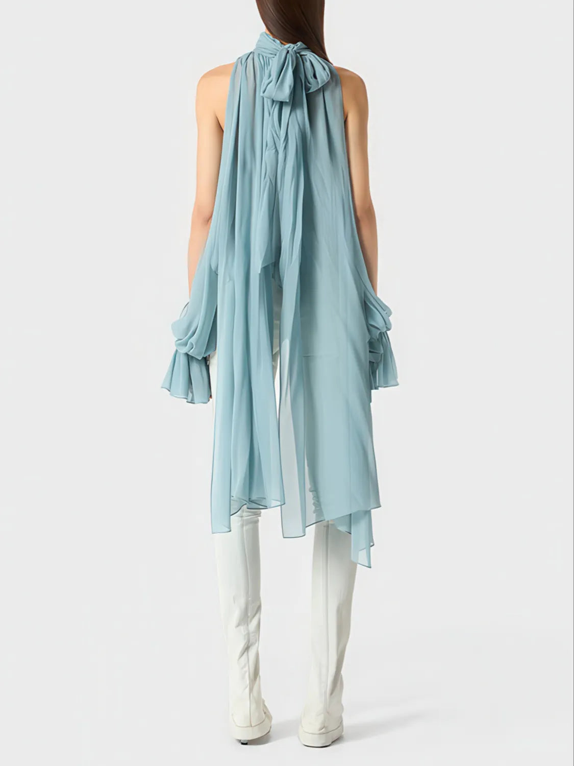 Light blue sleeveless top with a bow detail worn by a person on a white background. #Color_Blue