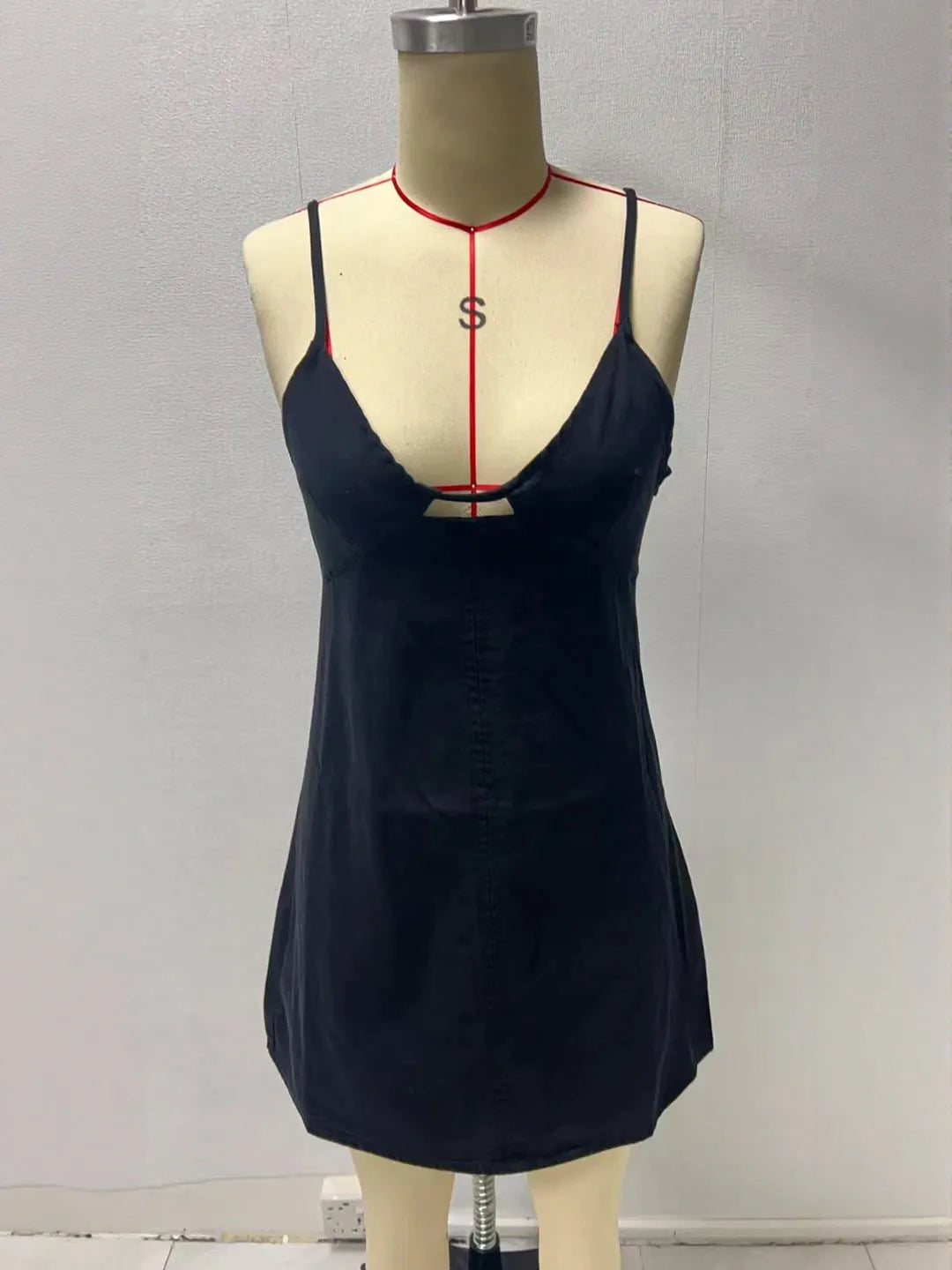 Black slip dress on a mannequin against a plain background. #Color_Black