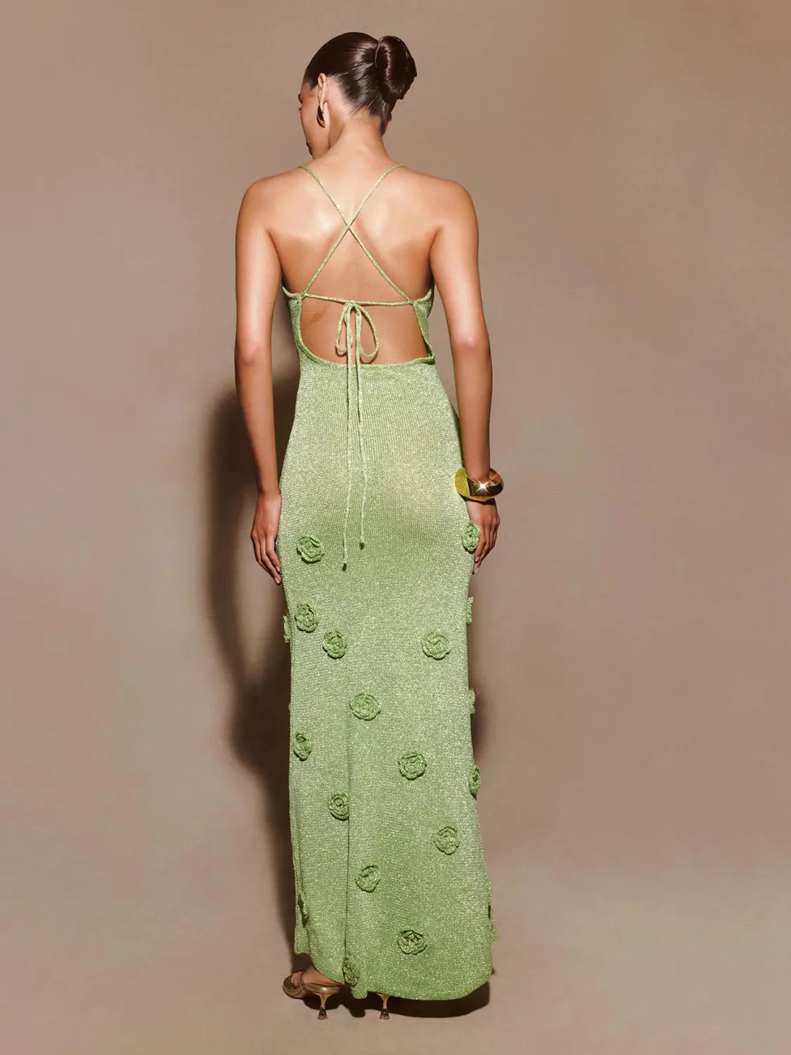 Woman wearing a green dress with floral patterns on a beige background #Color_Green