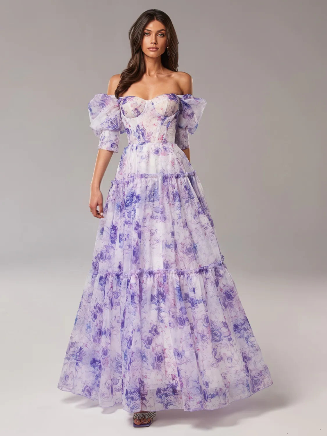 Woman wearing a purple floral off-shoulder gown on a gray background. #Color_Purple
