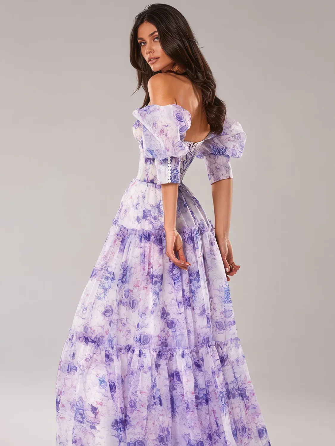 Woman wearing a purple floral dress against a gray background. #Color_Purple