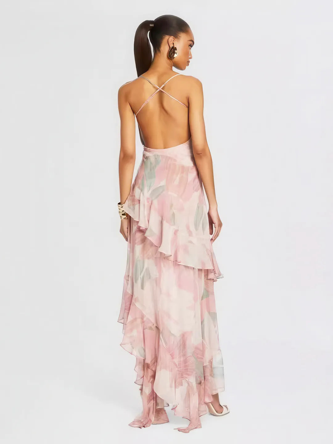 Woman wearing a pink floral dress with a white background