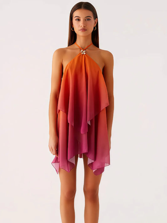 Woman wearing a halter neck dress with an ombre effect from orange to pink on a white background. #Color_OrangeRed