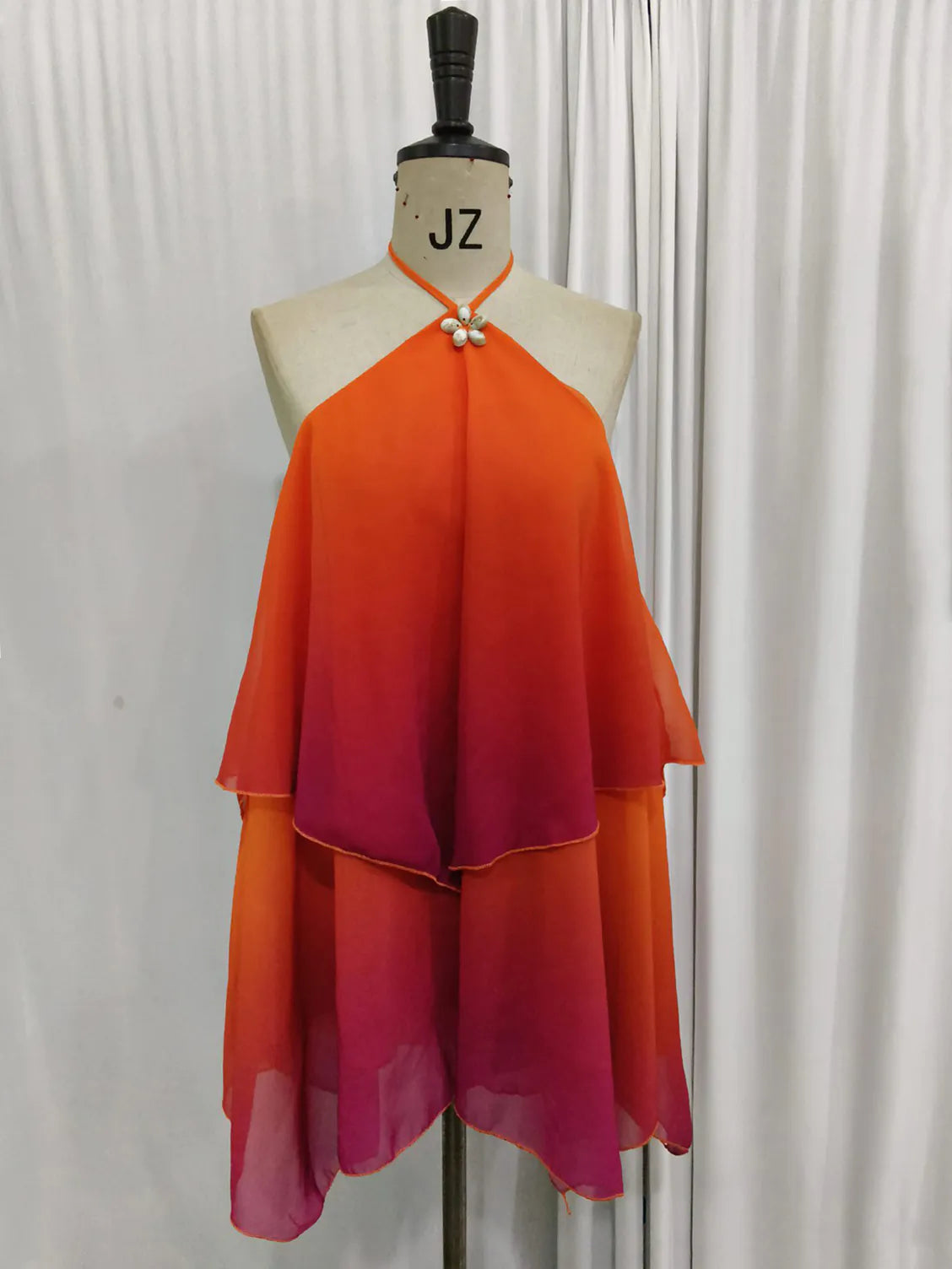 Mannequin wearing an orange and pink gradient dress with 'JZ' branding on a white background. #Color_OrangeRed