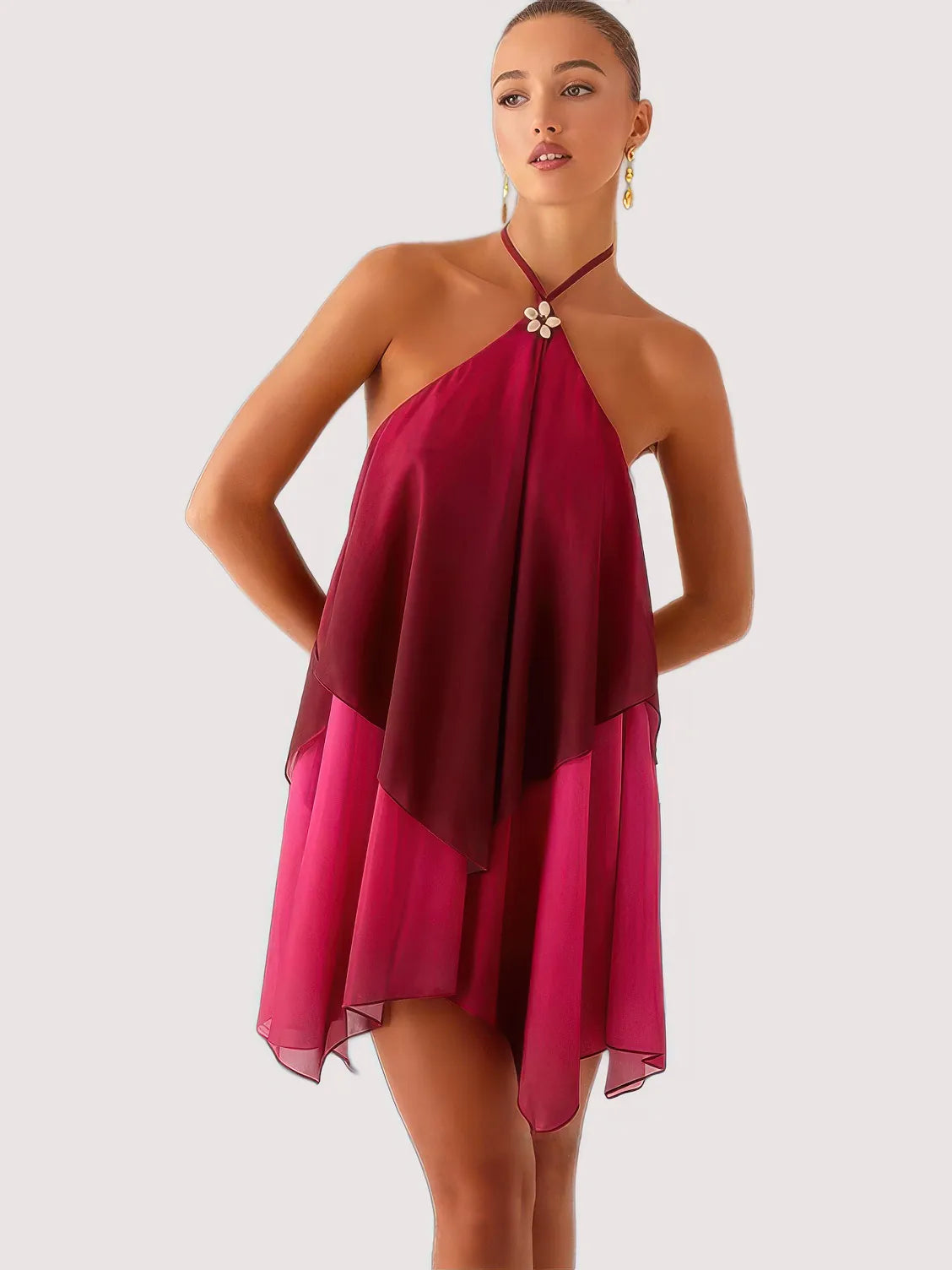 Woman wearing a halter neck dress with a gradient of pink and red on a white background. #Color_DarkRed