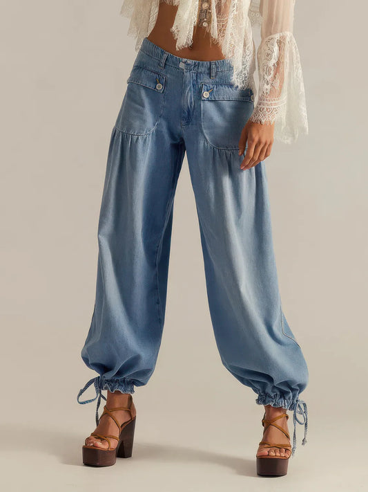 Light blue denim pants worn by a person on a plain background. #Color_LightBlue