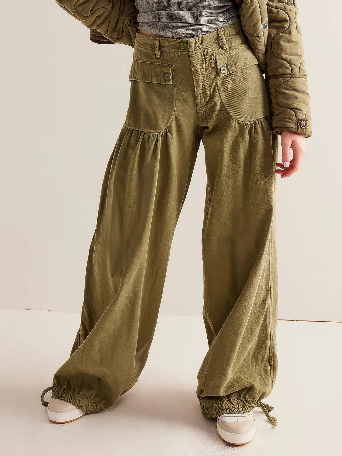 Person wearing olive green wide-leg pants and a matching jacket on a plain background. #Color_OliveDrab