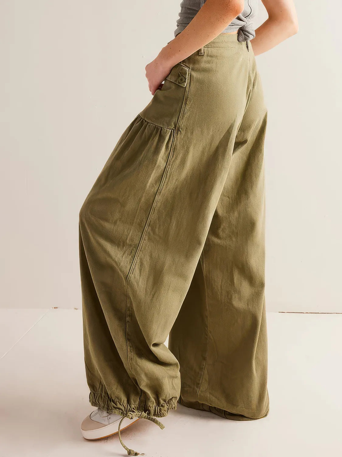 Person wearing olive green wide-leg pants on a plain background. #Color_OliveDrab
