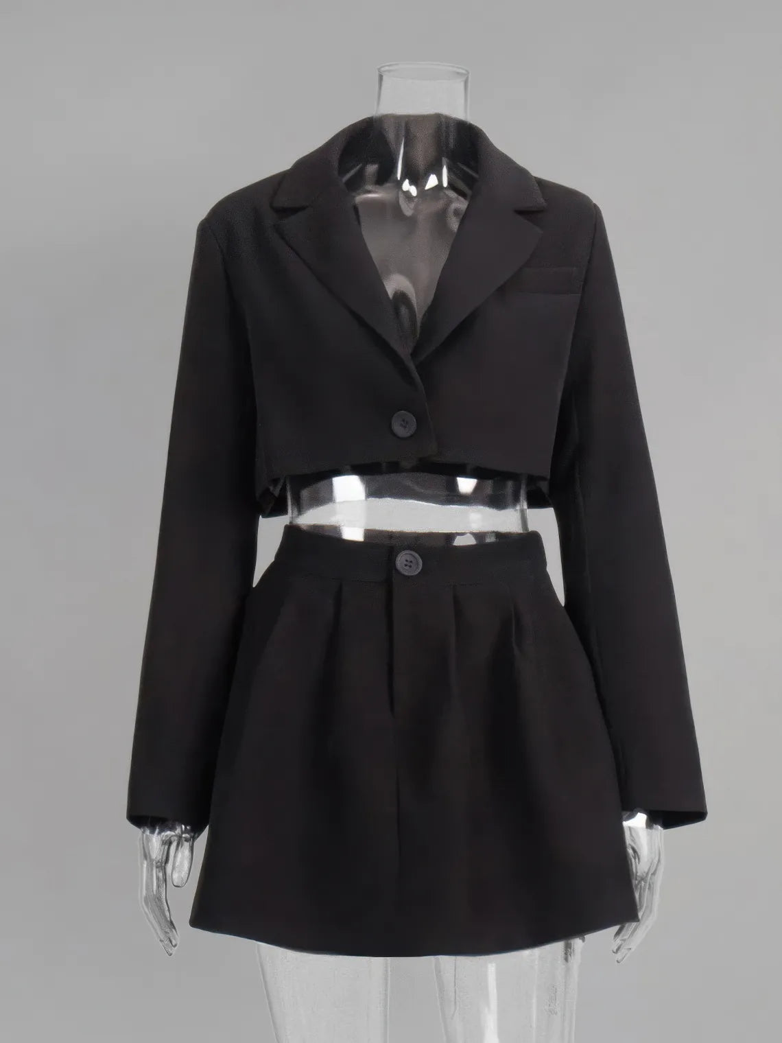 Black jacket and skirt set on a mannequin against a gray background. #Color_Black