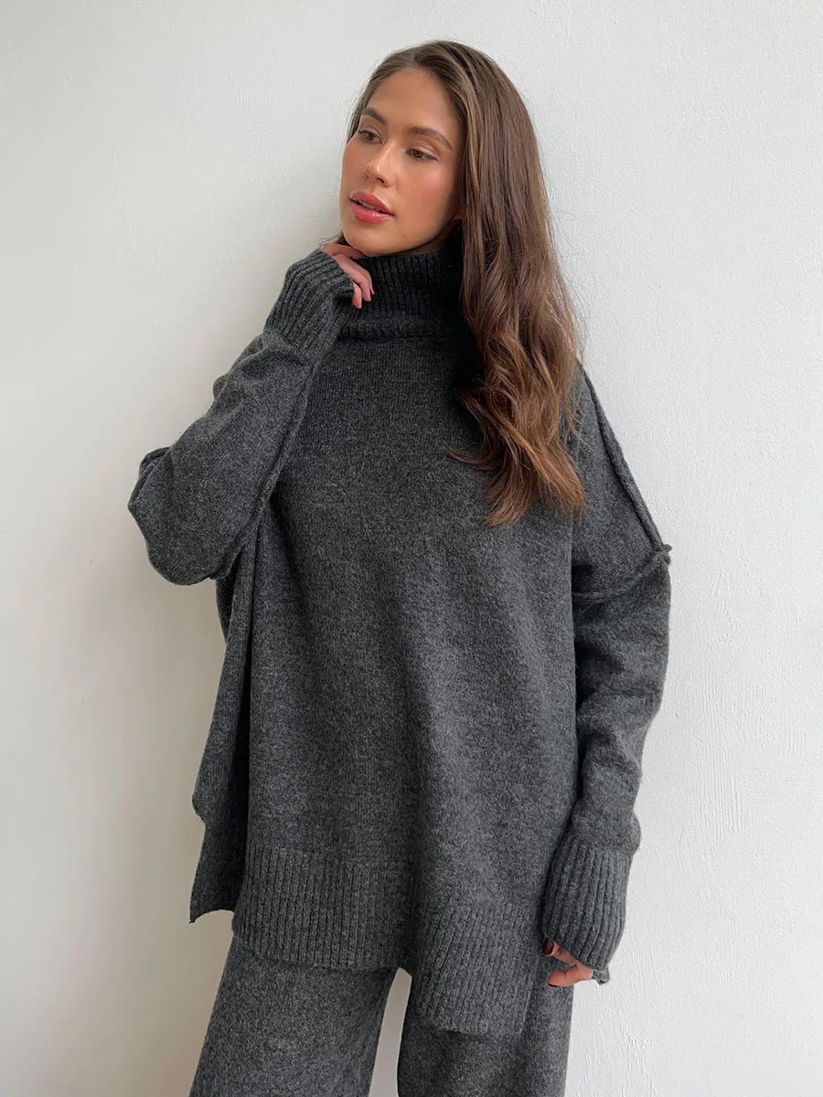 Woman wearing a gray oversized sweater against a white background. #Color_DimGray