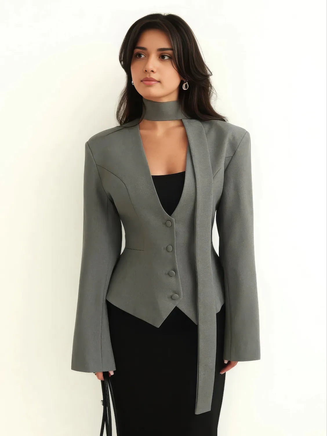 Woman wearing a gray blazer over a black top on a white background. #Color_Gray